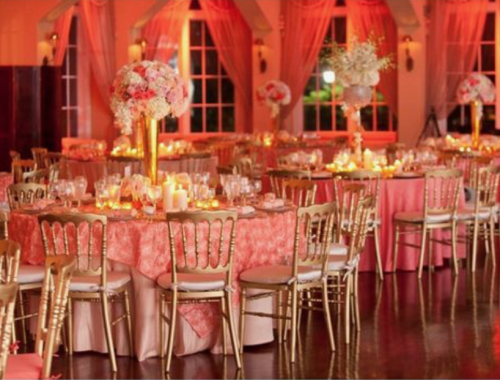 Tables and chairs in living coral colour at wedding venue